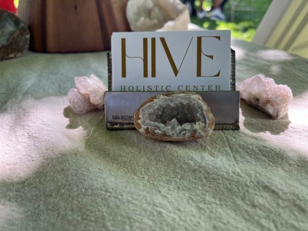 Hive Holistic Center card with crystals and a geode